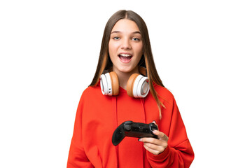 Obraz premium Teenager caucasian girl playing with a video game controller over isolated background with surprise facial expression