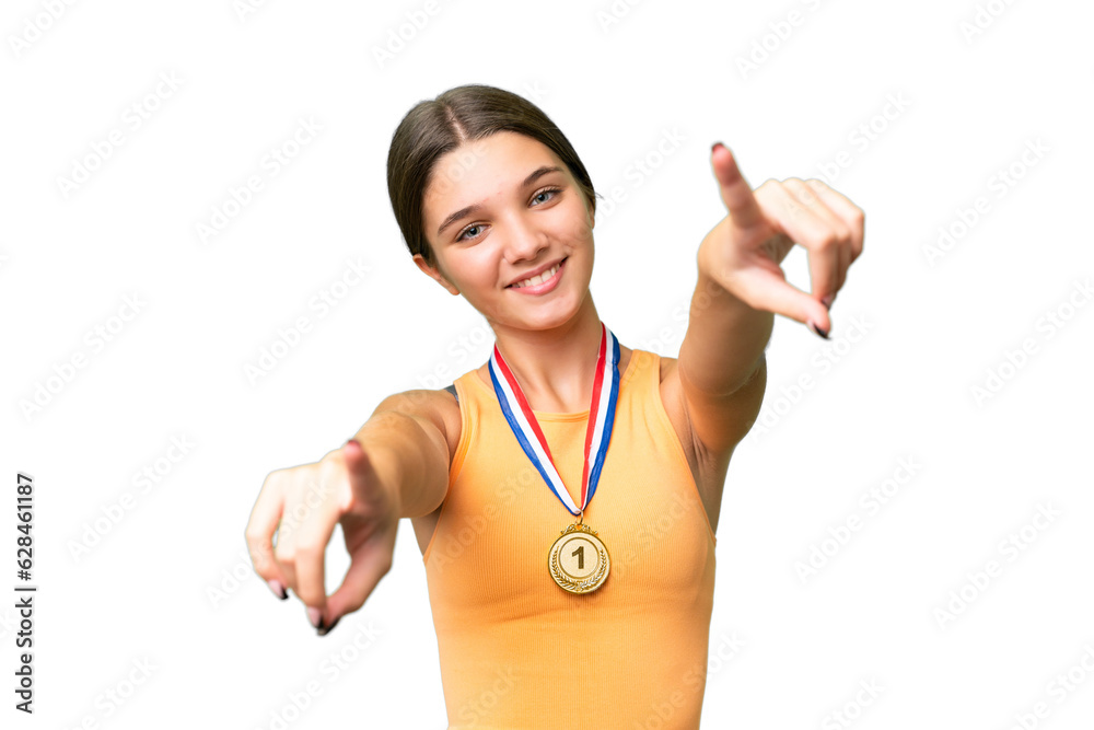 Canvas Prints Teenager caucasian girl with medals over isolated background points finger at you while smiling