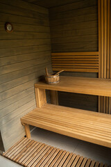 Modern wooden Finnish sauna interior with wooden benches. Wooden interior baths, wooden benches and loungers accessories for sauna, spa complex.