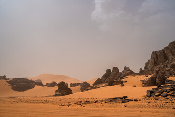 Fototapeta na wymiar iew in the Sahara desert of Tadrart rouge tassili najer in Djanet City ,Algeria.colorful orange sand, rocky mountains