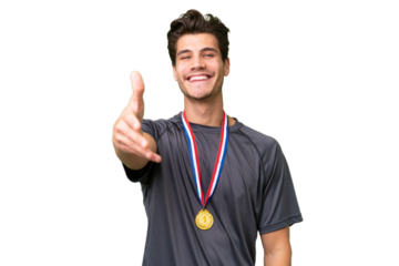 Young caucasian man with medals over isolated background shaking hands for closing a good deal