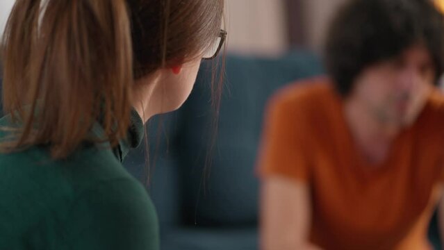 Male patient in the consultation of a female psychiatrist. Mental health. Holding hands. Close-up.