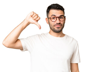 Young handsome caucasian man over isolated chroma key background showing thumb down with negative...