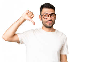 Young handsome caucasian man over isolated chroma key background showing thumb down with negative expression