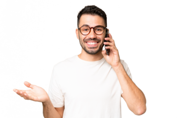 Young handsome caucasian man over isolated chroma key background keeping a conversation with the mobile phone with someone