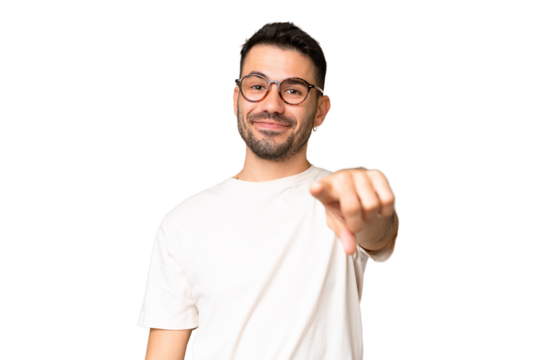 Young handsome caucasian man over isolated chroma key background pointing front with happy expression