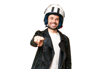 Young caucasian man with a motorcycle helmet over isolated chroma key background pointing front with happy expression