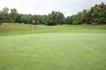 golf course with flag at the green