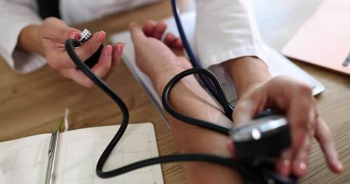Doctor measuring blood pressure of patients with stethoscope and tonometer. Blood pressure results and cardiovascular disease