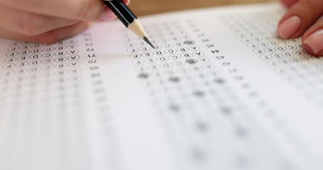 Person solves tests and writes with pencil on paper. Multiple choice exam or student testing