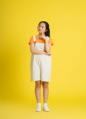 cute asian girl posing on a yellow background