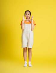 cute asian girl posing on a yellow background