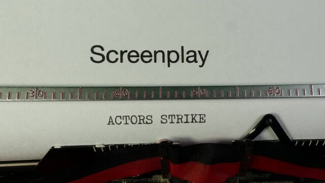 Industrial action.Typing Writers Strike on a blank screenplay on an old manual typewriter. Entertainment industry film and television.