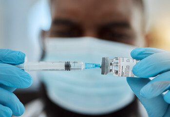 Medicine, vaccine and a doctor man with a syringe and mask for virus, health care and cure in hospital. Hands of person with a pharmaceutical product, vial or container for treatment or injection