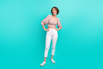 Full length photo of minded creative positive person put hands waist look empty space ad isolated on aquamarine color background