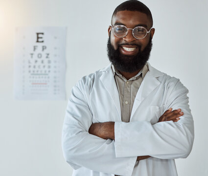 Eye Exam, Portrait And Black Man Or Doctor With Arms Crossed And Glasses With Happy Service In Healthcare. Ophthalmology, Face And Expert To Check Vision, Test Or Assessment For Eyes Or Health