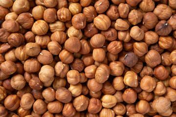 Hazelnuts harvest. Filbert photo wallpaper. Full frame of hazel. Cobnut background. Peeled brown nut kernels. Healthy organic bio products. Vegetarian, vegan and raw food. Back to nature. Healthy fat
