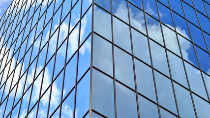 Obraz premium Structural glass wall reflecting blue sky. Abstract modern architecture fragment. Glass building with transparent facade of the building and blue sky. Contemporary architectural background.