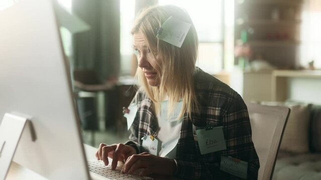 Nervous stressed blond mature woman freelancer with stickers typing quickly on computer and looking at papers asking to hurry up scream and warning about deadline at home workplace