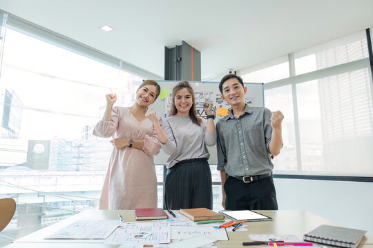 Asian female leader and ux ui designer clapping hand for successful of mobile app interface wireframe design at modern office. Creative digital development agency