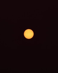Sunrise with Canada's wildfires: The sun shines through the dust suspended on the black background