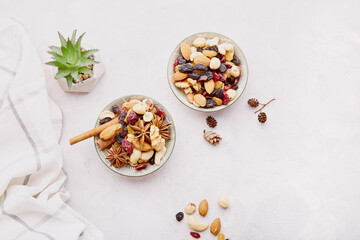 Aesthetic saucers with different nuts. Healthy desserts and snacks. Walnuts, almonds, hazelnuts and cashews. Raisins and cranberries on white background.