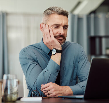 Confused, Bored And Business Man At Laptop In Office With Stress, Fatigue And Problem. Computer, Tired And Mature Manager With Doubt, Financial Crisis And Reading Debt Email, Tax Audit And Burnout