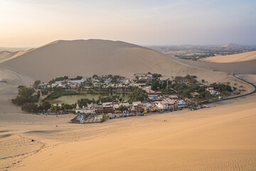 Ica, Peru - May 31, 2022. View of a Buggy car and tourists ready to ride the Huacachina dunes in Ica during the sunset - 628491973