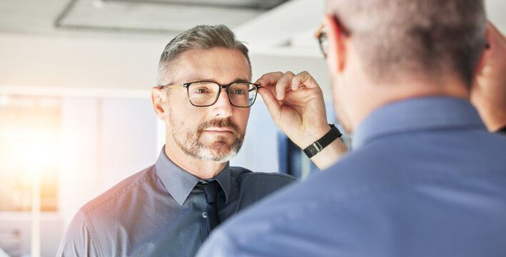 Mirror reflection, optometry and man with glasses for eye care, vision and choice of frame. Mature, store and person eyewear shopping for a lens or fit for eyeglasses style in a shop with a decision
