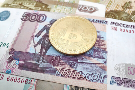 Bitcoin on top of a stack of Russian Ruble banknotes