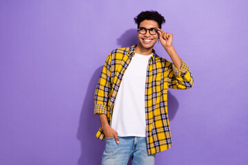 Photo of cute dreamy guy wear plaid yellow shirt arm spectacles looking empty space empty space isolated violet color background