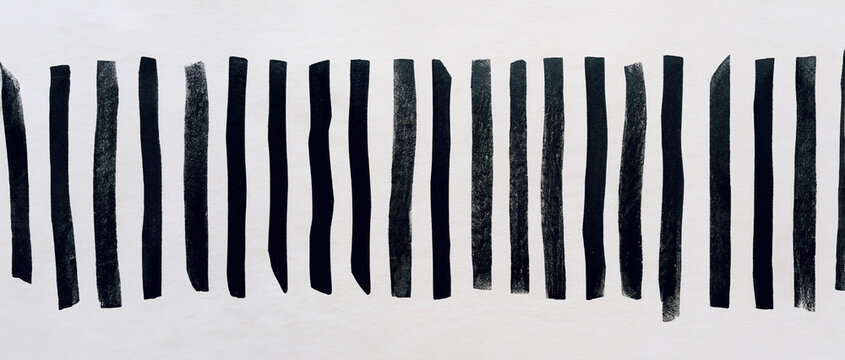 immagine primo piano di spesse righe verticali in inchiostro nero su carta ruvida, vista dall'alto