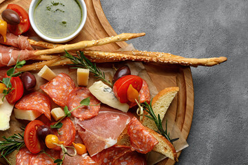 Delicious cheese and charcuterie spread on board, close-up