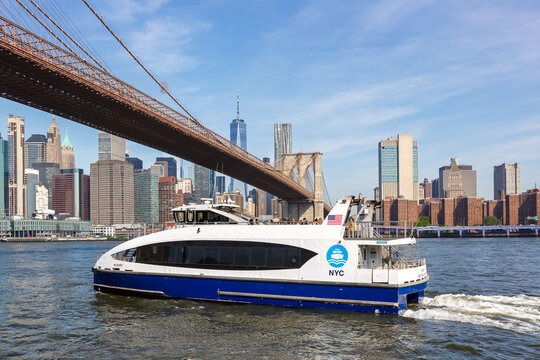 New York City skyline of Manhattan with Brooklyn Bridge, World Trade Center skyscraper and ferry in the United States