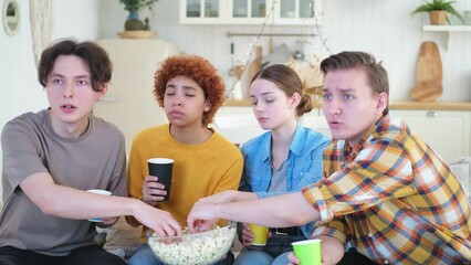 Group of friends watching sport match soccer football game on tv at home. Football fans disappointed missing goal loosing game. Friendship sports entertainment. Buddies watching championship together