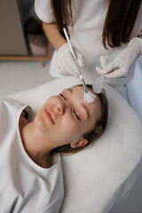 Applying gel on a woman's face. Care for a woman's face.