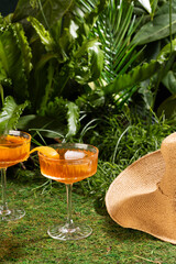 Aperol spritz cocktail in a crystal glass on a tropical background