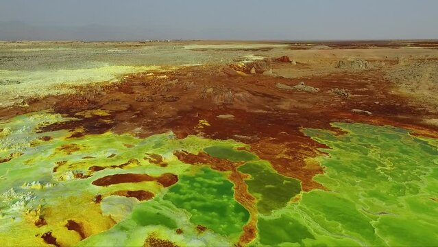 Journey to the Danakil Desert, Ethiopia. The colorful landscape of Dallol lake in Crater of Volcano. Sulphur springs. Hottest place on the Earth. Acid lake, Danakil desert by drone.