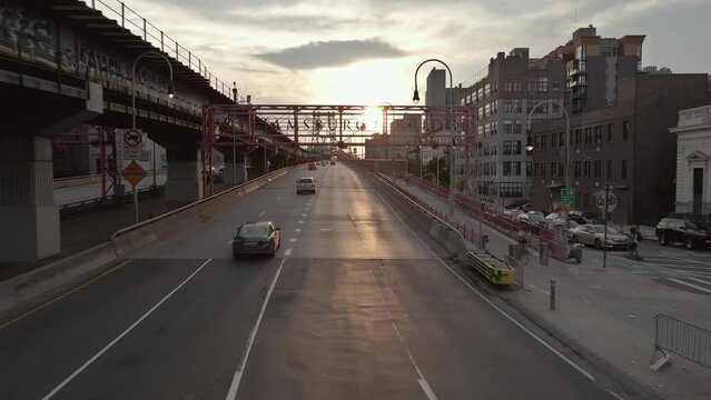 One can witness breathtaking panoramic view of Manhattan across East River, with Williamsburg Bridge in New York City, during sunset