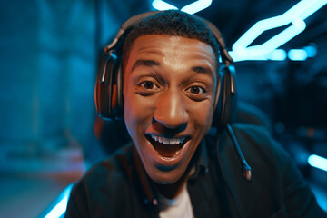 Fototapeta premium Portrait of a happy computer gamer in headphones.