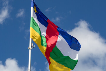 Central african republic flag in the blue sky. horizontal panoramic banner. Close-up of waving the...