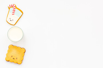 Funny cookies in shape of milk in glass and biscuit, top view