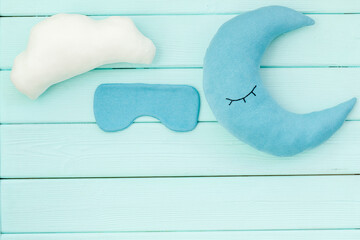 Good night concept. Sleep mask and moon pillow, top view
