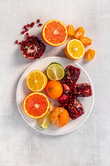 Creative flatlay layout of juicy pomegranate and citrus