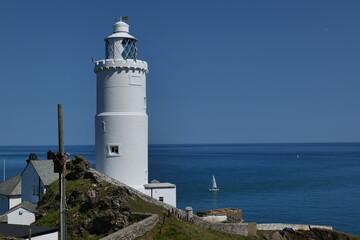 Fototapeta na wymiar Lighthouse on the coast of the sea