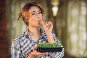 A woman eats microgreens