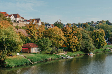 Fototapeta na wymiar Autumn Landscape - River And Shores With Trees, Bushes And City Houses Marbach Am Neckar. Panoramic Aerial View Of The River In A City Park. Deciduous Trees, Golden Leaves. Autumn Landscape. Ecology