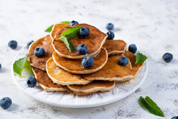 Pancakes with honey and blueberries. Sweet homemade pancakes