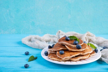 Pancakes with honey and blueberries. Sweet homemade pancakes