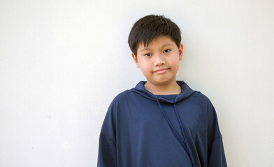 Portrait of a Cute Asian kids boy in a hoodie posing standing smiling in a happy isolated on white background.cute Asian boy fashion